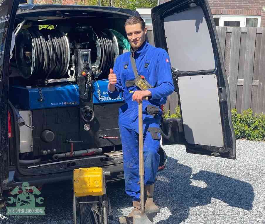 Een monteur met gereedschapsriem en klembord, klaar om een transparant vast tarief te geven voor het ontstoppen in Leidschendam