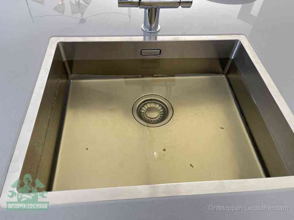 Een RVS spoelbak met stilstaand water dat niet wegloopt, een van de eerste signalen van een beginnende verstopping in Leidschendam